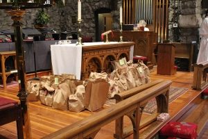 ABCCM Food Drive Bags Full of Food In Fron of Altar